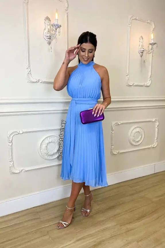 Woman in a blue dress with a purple purse