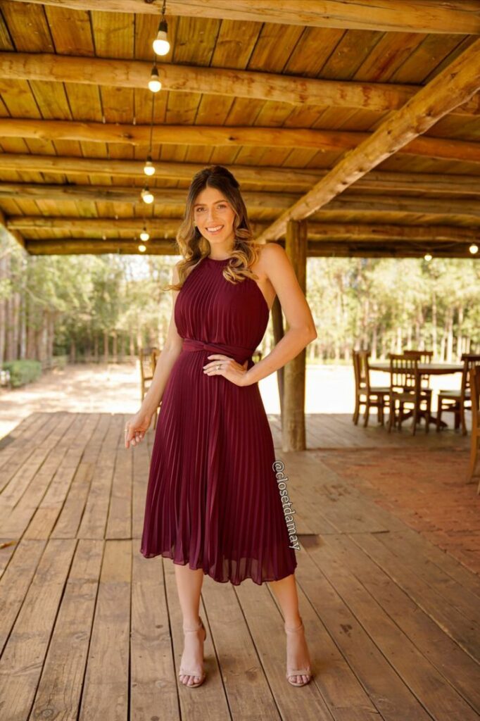 Woman in a burgundy dress with nude shoes