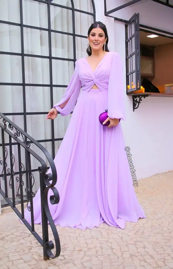Woman in lilac dress with a purple clutch bag