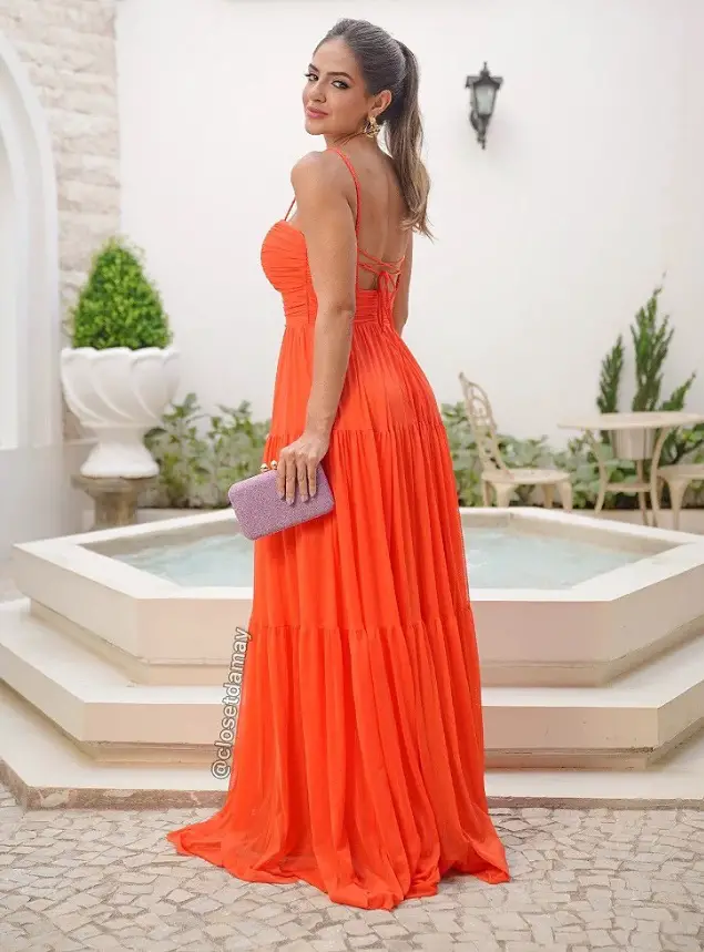 Woman in an orange dress with green nails