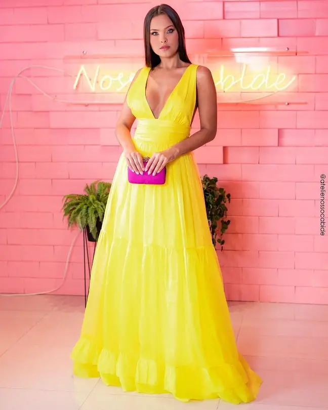 Yellow dress with a fuchsia clutch bag