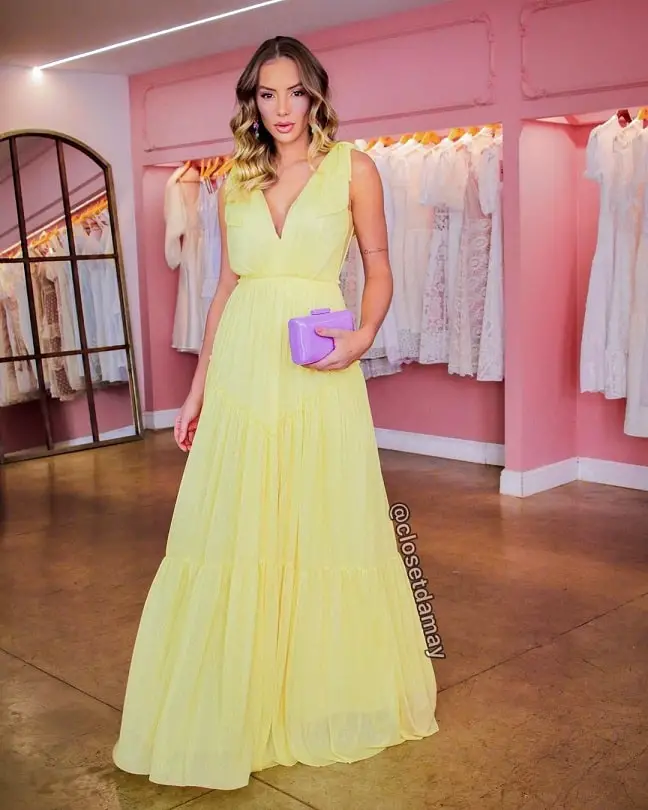 Yellow dress with a lavender clutch bag