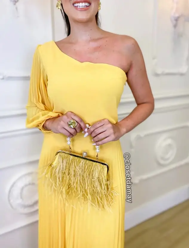 Yellow dress with a yellow clutch bag