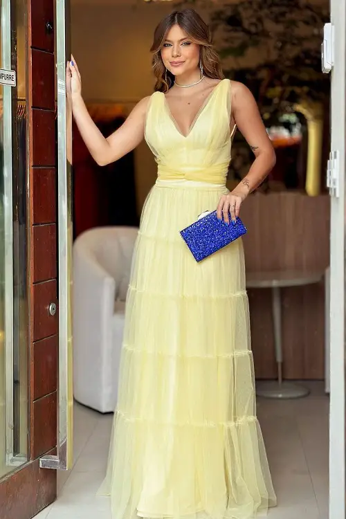 Yellow dress with blue nail polish