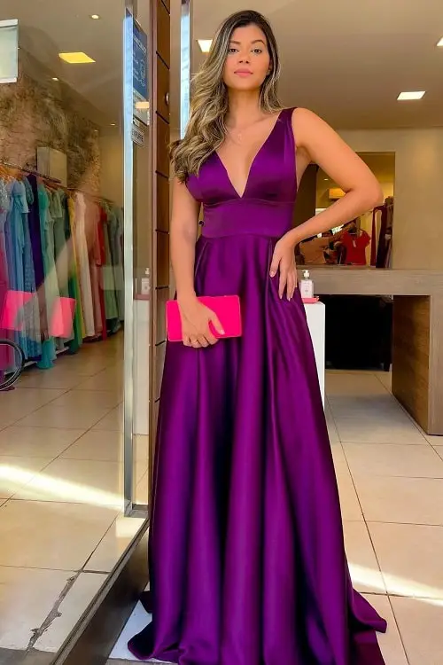 Purple dress with hot pink clutch bag